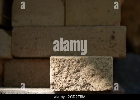 A podium made of rectangular beige stone to demonstrate your product on a stone background. High quality photo Stock Photo