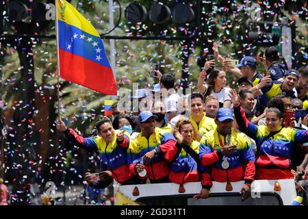 Caracas, Venezuela. 10th Aug, 2021. Keydomar Vallenilla (2nd from right) and Julio Mayora (2nd from left) show off their Olympic medals as they are cheered by fans upon arrival after the Tokyo Olympics. Credit: Jesus Vargas/dpa/Alamy Live News Stock Photo