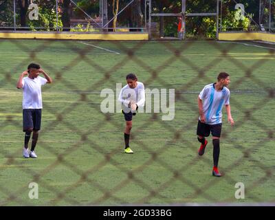 Medellin, Colombia - July 30 2021: Young Teenagers in Sportswear are Warming up on a Large Green Synthetic Field Stock Photo