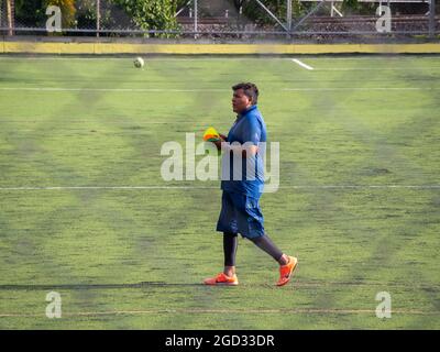 Medellin, Antioquia, Colombia - July 30 2021: Latin Man in Sportswear Walks with Cones on a Green Synthetic Field Stock Photo