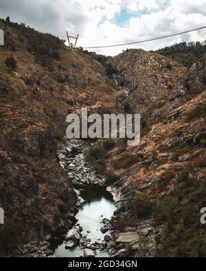 River between the hills and suspended bridge in Passadiços do Paiva in Arouca Stock Photo