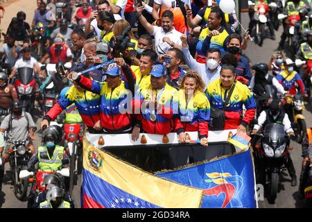 Caracas, Venezuela. 10th Aug, 2021. Keydomar Vallenilla (2nd from right) and Julio Mayora (middle) show off their Olympic medals as they are cheered by fans upon arrival after the Tokyo Olympics. Credit: Pedro Rances Mattey/dpa/Alamy Live News Stock Photo