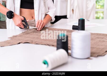Multiethnic team of fashion designers working working in a clothing start-up workshop - Multiracial group of stylists, tailor designers and dressmaker Stock Photo