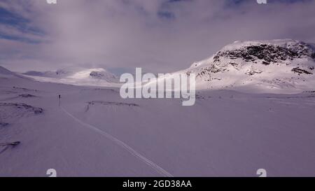 A tiny lonely skier in Lapland near Alesjaure, Sweden, early April Stock Photo