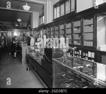 Employees behind display cases at the Offterdinger Cigar Store in Washington DC ca.  between 1910 and 1926 Stock Photo