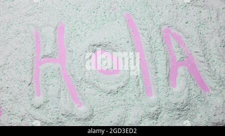 Hello Spanish, speak HOLA Spanish. Powder texture. Stock Photo