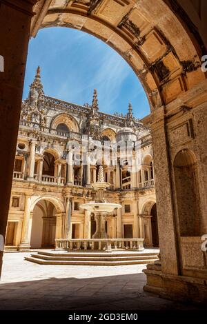 Tomar, Portugal - June 3, 2021: Main cloister of the Convento de Cristo in Tomar, Portugal, seen through one of the arches. Stock Photo