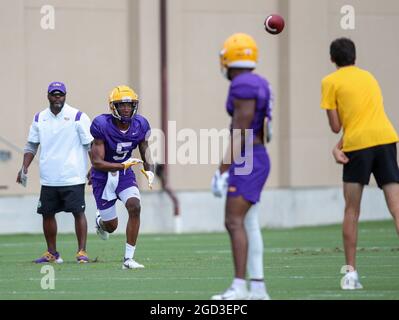 August 10, 2021: LSU defensive back Jay Ward (5) breaks on a pass as Defensive Coordinator Daronte Jones looks on during the first week of fall football camp at the LSU Charles McClendon Practice Facility in Baton Rouge, LA. Jonathan Mailhes/CSM Stock Photo