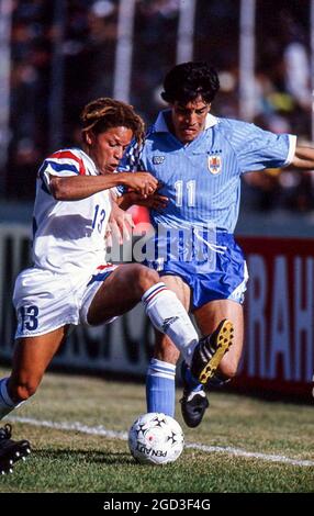 Cobi Jones of the United States battles against Adrian Paz of Uruguay in a 1993 Copa Americaa match in Ambato, Ecuador. Stock Photo