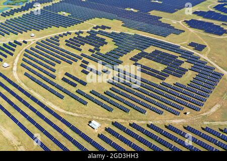 Datong. 4th Aug, 2021. Aerial photo taken on Aug. 4, 2021 shows a photovoltaic power station in Tujing Village, Yunzhou District of Datong City, north China's Shanxi Province. The photovoltaic power station, built upon 1,851 mu (123.4 hectares) of saline-alkaline land, generates over 80 million KWH of power per year. Credit: Cao Yang/Xinhua/Alamy Live News Stock Photo