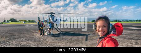 Helicopter ride Asian tourist passenger woman boarding flight on cruise excursion activity in Hawaii. Panoramic banner of summer travel vacation Stock Photo