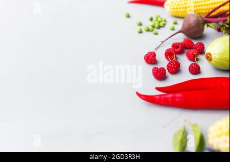 Flat lay with different vegetables, fruits, berries, nuts, spices, herbs, olive oil. Copy space area for some text. Veggies on grey concrete backgroun Stock Photo