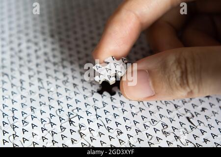 Put the last piece of jigsaw in its place Stock Photo