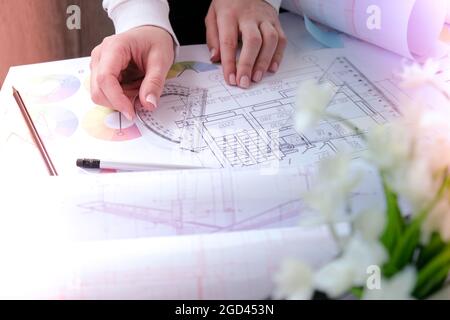 Hands use pencil with a protractor. Architectural Project drawings with tools. Architects workplace. Engineering Interior designer's working table. Wo Stock Photo
