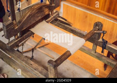 Village women busy weaving silk saree on handloom Stock Photo