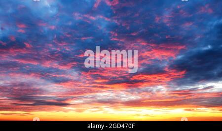 Sky at color sunset with orange red clouds Stock Photo