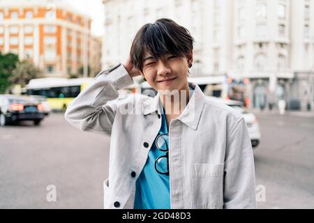 Cool asian man posing and looking at camera in the city of Madrid. Stock Photo