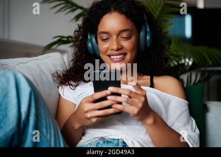 Mixed race female teen relaxing on home Stock Photo