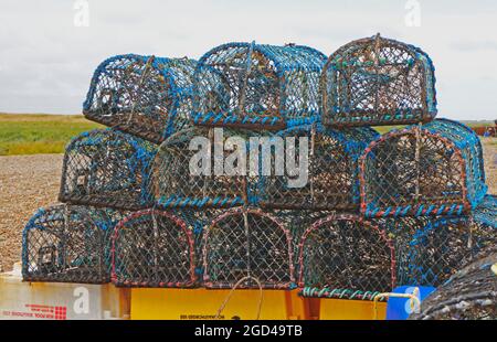 Crab pots stored above high water level for inshore fishing on the North Norfolk coast at Cley-next-the-Sea, Norfolk, England, United Kingdom. Stock Photo