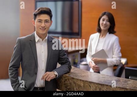 Businessman checking in at front desk Stock Photo