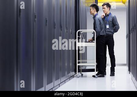 Technicians doing maintenance in computer room Stock Photo