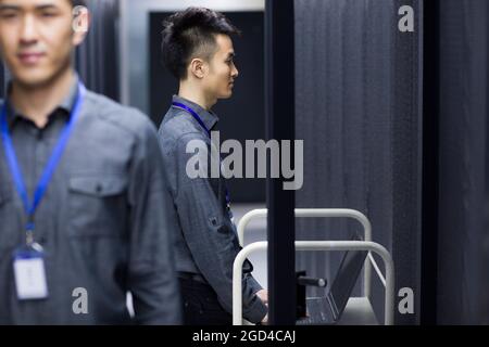 Businessman using laptop in computer room Stock Photo