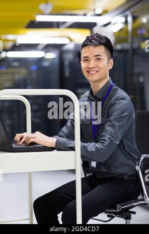 Businessman using laptop in computer room Stock Photo