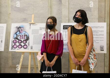 Non Exclusive: KYIV, UKRAINE - AUGUST 10, 2021 - Visitors in face masks are pictured during the opening of the SHE is SCIENCE exhibition that features Stock Photo