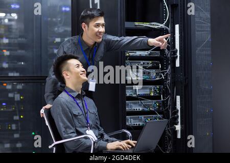 Technicians doing maintenance in computer room Stock Photo