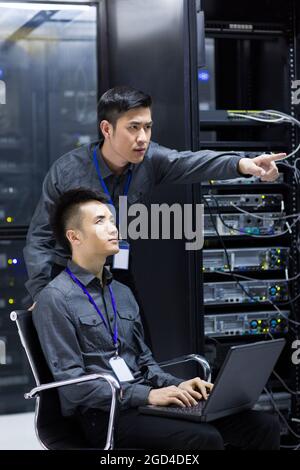 Technicians doing maintenance in computer room Stock Photo