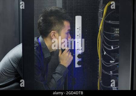 Technician doing maintenance in computer room Stock Photo