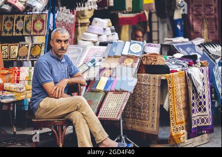 CAIRO, EGYPT - Jun 06, 2021: A closeup shot an Egyptian man on the market selling different traditional objects Stock Photo