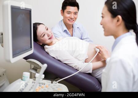 Pregnant woman having fetal sonogram Stock Photo