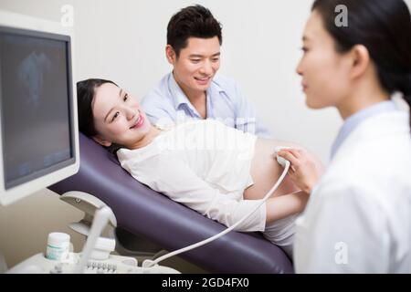 Pregnant woman having fetal sonogram Stock Photo