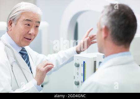 Doctors with MRI scanner Stock Photo