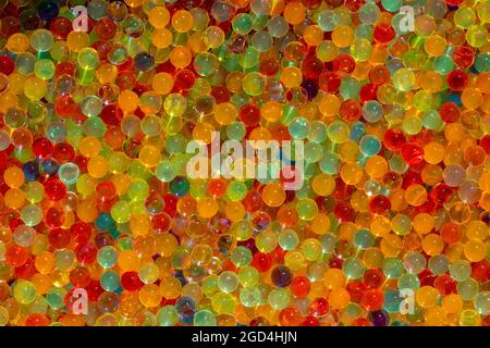 Lots of different colored hydrogel balls. Set of multicolored orbis. Crystal water beads for games. ideal for backgrounds or textures Stock Photo