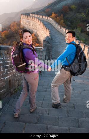 Young couple enjoying autumn outing on Great Wall Stock Photo