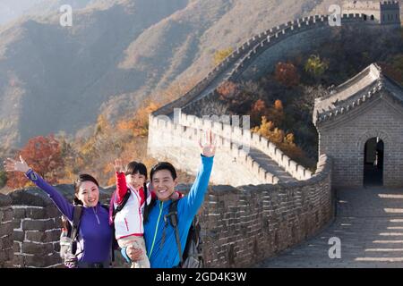 Young family enjoying autumn outing on Great Wall Stock Photo