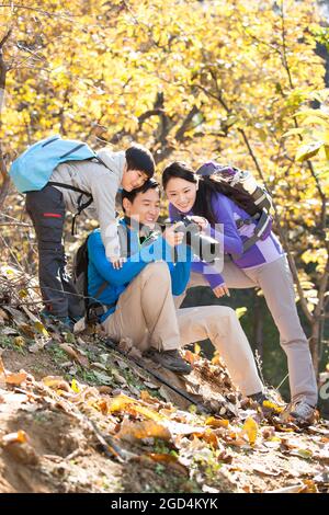 Young family taking pictures on a hike Stock Photo