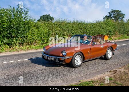1978 70s brown Triumph Spitfire 2dr cabrio British front-engined, rear-wheel drive, two-passenger convertible, en-route to Capesthorne Hall classic July car show, Cheshire, UK Stock Photo