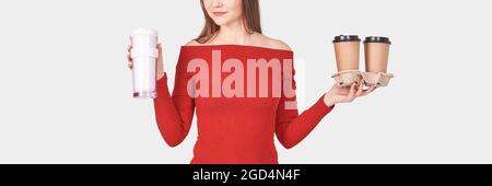 Pretty young woman with coffee cup. Studio portrait. Stock Photo