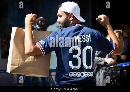 Paris, France. 11th Aug, 2021. A supporter shows a jersey of PSG's Argentinian football player Lionel Messi, that he has just bought at the Paris-Saint-Germain (PSG) football club store on the Champs Elysees avenue in Paris on August 11, 2021. Messi signed on August 10, 2021 a two-year deal with PSG with the option of an additional year. The 34-year-old will wear the number 30 in Paris, the number he had when he began his professional career at Barca. Photo by Raphael Lafargue/ABACAPRESS.COM Credit: Abaca Press/Alamy Live News