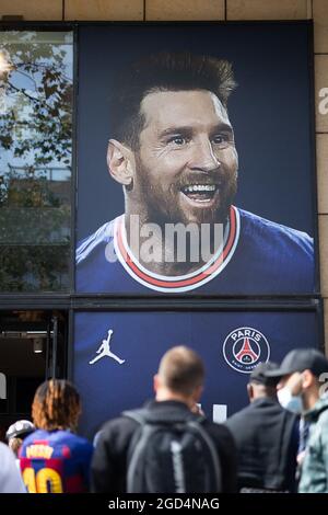 Paris, France. 11th Aug, 2021. A supporter shows a jersey of PSG's  Argentinian football player Lionel Messi, that he has just bought at the  Paris-Saint-Germain (PSG) football club store on the Champs