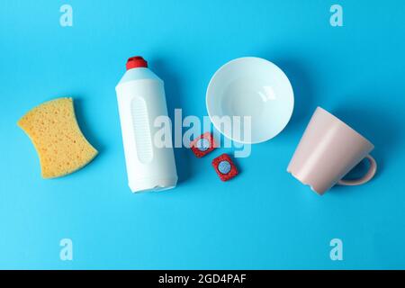 Concept of Dishwashing detergent accessories on blue background Stock Photo