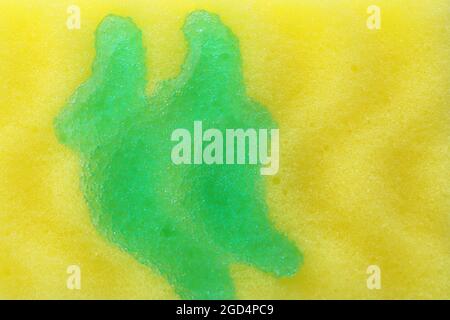 Yellow sponge with dishwashing detergent, close up Stock Photo