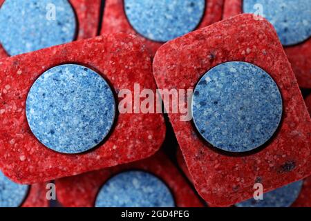 Dishwashing tablets on whole background, close up Stock Photo