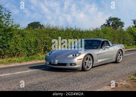 2005 silverAmerican  V8 Chevrolet Chevy Corvette coupe, 5987cc American pony car en-route to Capesthorne Hall classic July car show, Cheshire, UK Stock Photo