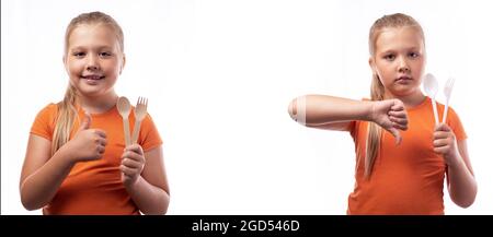 Cute caucasian little girl holding bamboo cutlery and plastic cutlery on a white background. Bamboo cutlery made of wood. Zero waste concept, recyclin Stock Photo