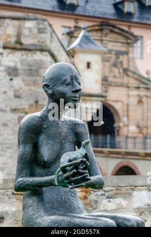 July 2021, Erfurt Germany, Man with an animal, a new sculpture in Erfurt in the rain Stock Photo