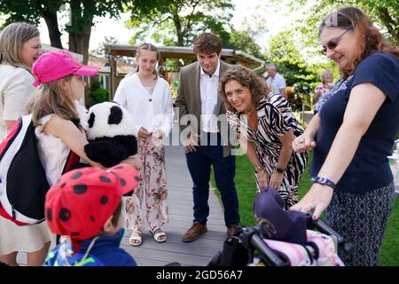 Captain Sir Tom Moore's daughter Hannah Ingram-Moore alongside his grandchildren Benjie Ingram-Moore and Georgia Ingram-Moore meet Finley and Lucy Middleton, during the official opening of a new garden at the Helen and Douglas House children's hospice in Oxford. Picture date: Wednesday August 11, 2021. Stock Photo